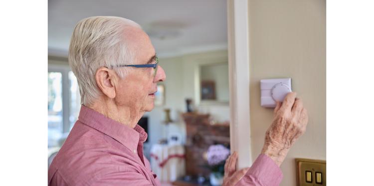 man with thermostat